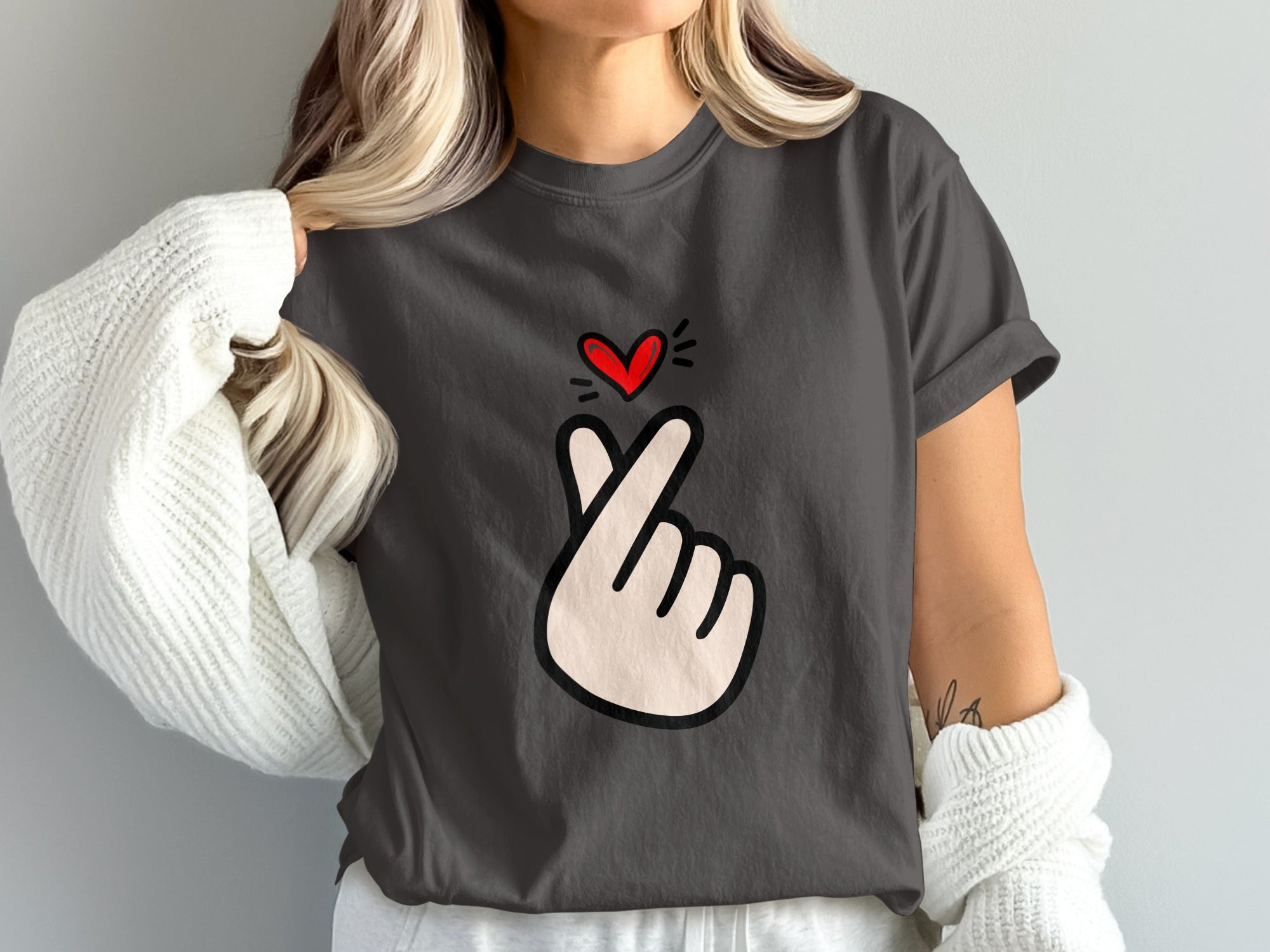 Dark grey t-shirt with a white hand forming a heart gesture and a red heart.