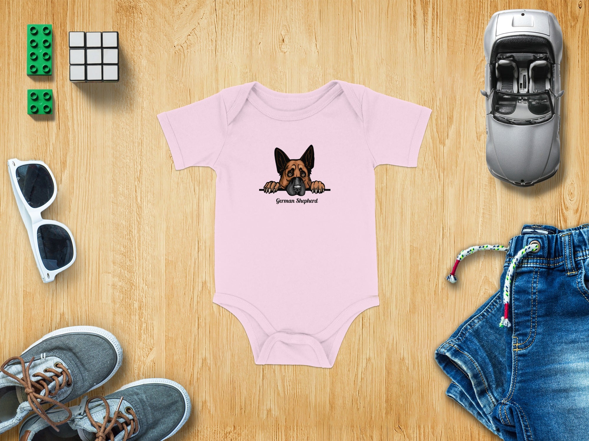Pink baby onesie with a German Shepherd graphic and text.