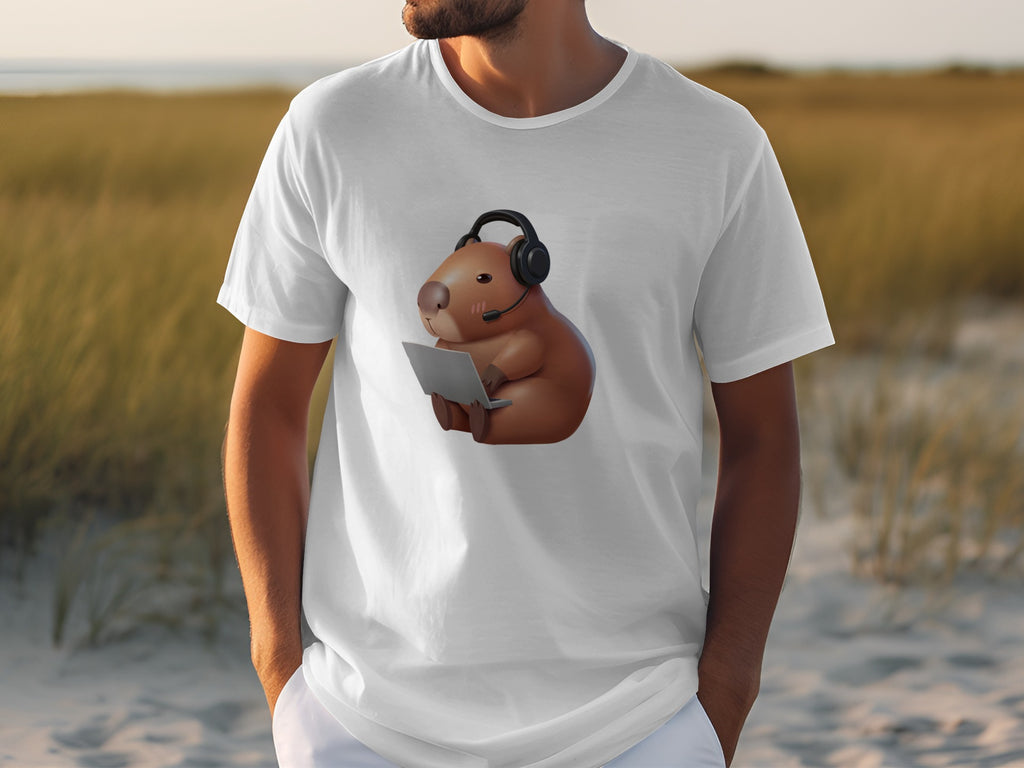 White t-shirt with graphic of a cartoon capybara wearing headphones and holding a laptop.