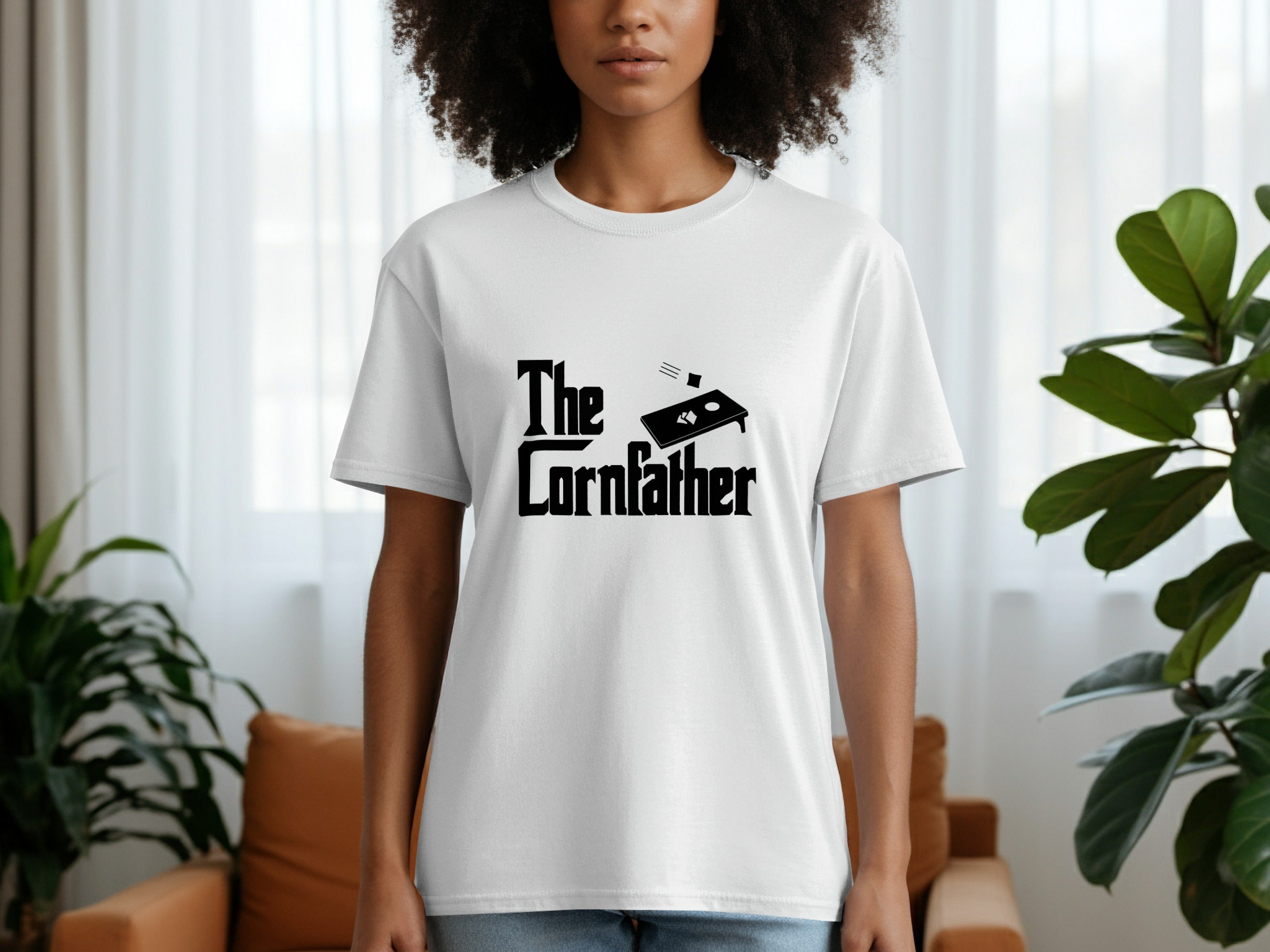 White t-shirt with black text and bean bag toss graphic that reads "The Cornfather".