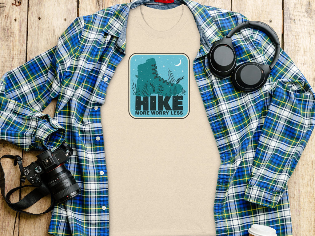 T-shirt with "HIKE MORE WORRY LESS" graphic of a boot and moon.