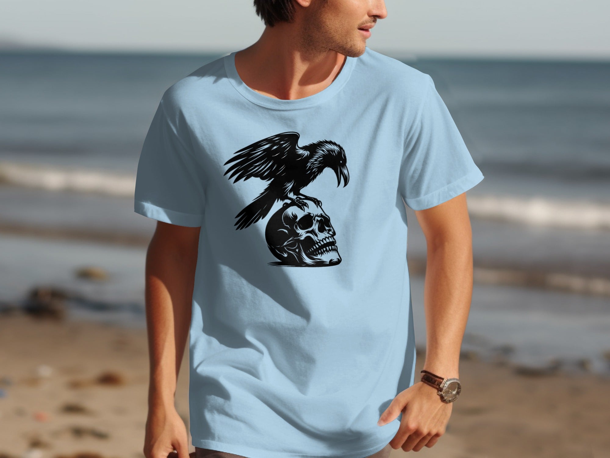 Light blue t-shirt with black graphic of crow perched on a skull.