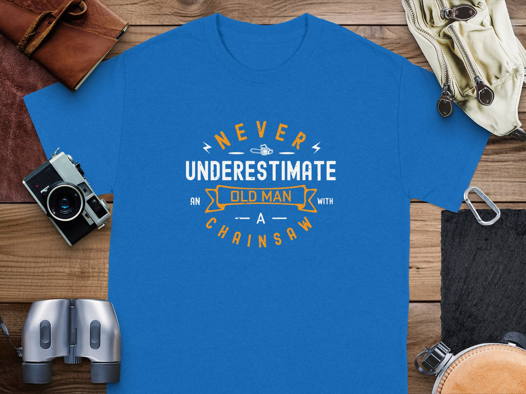 Blue t-shirt with text "Never underestimate an old man with a chainsaw".