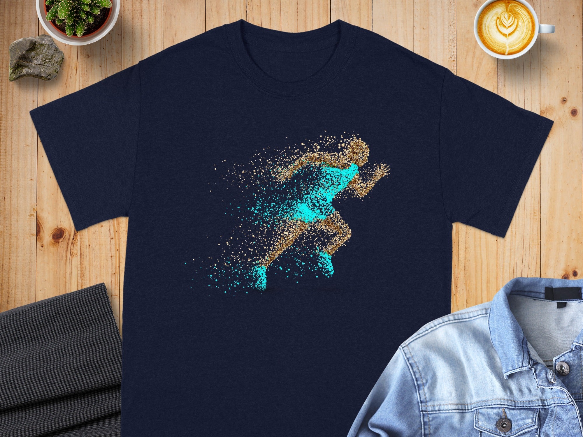 Navy t-shirt with a design of a runner made of gold and turquoise particles.