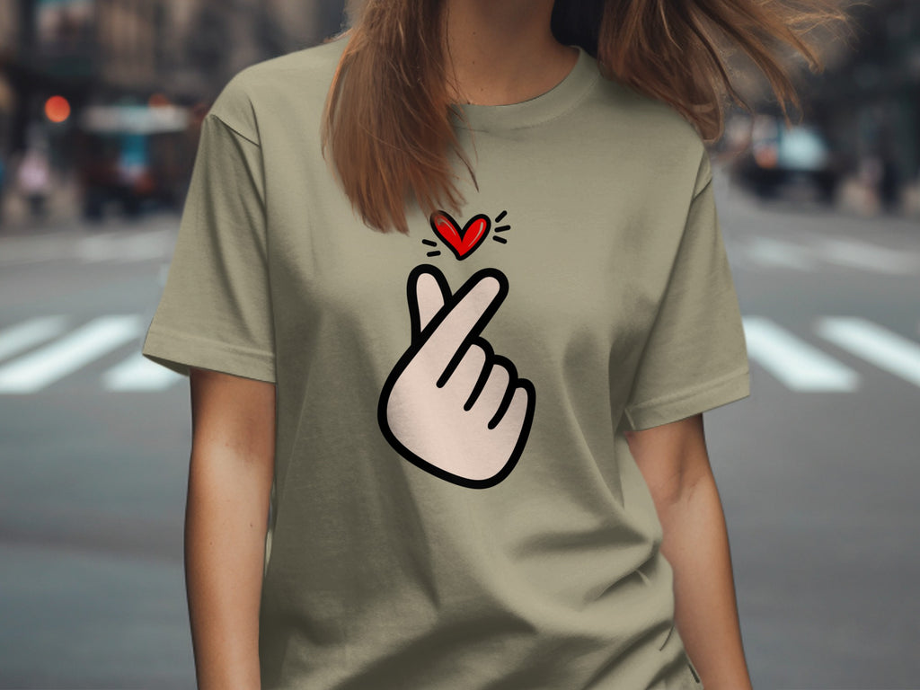Light green t-shirt with a cartoon finger heart and red heart graphic.