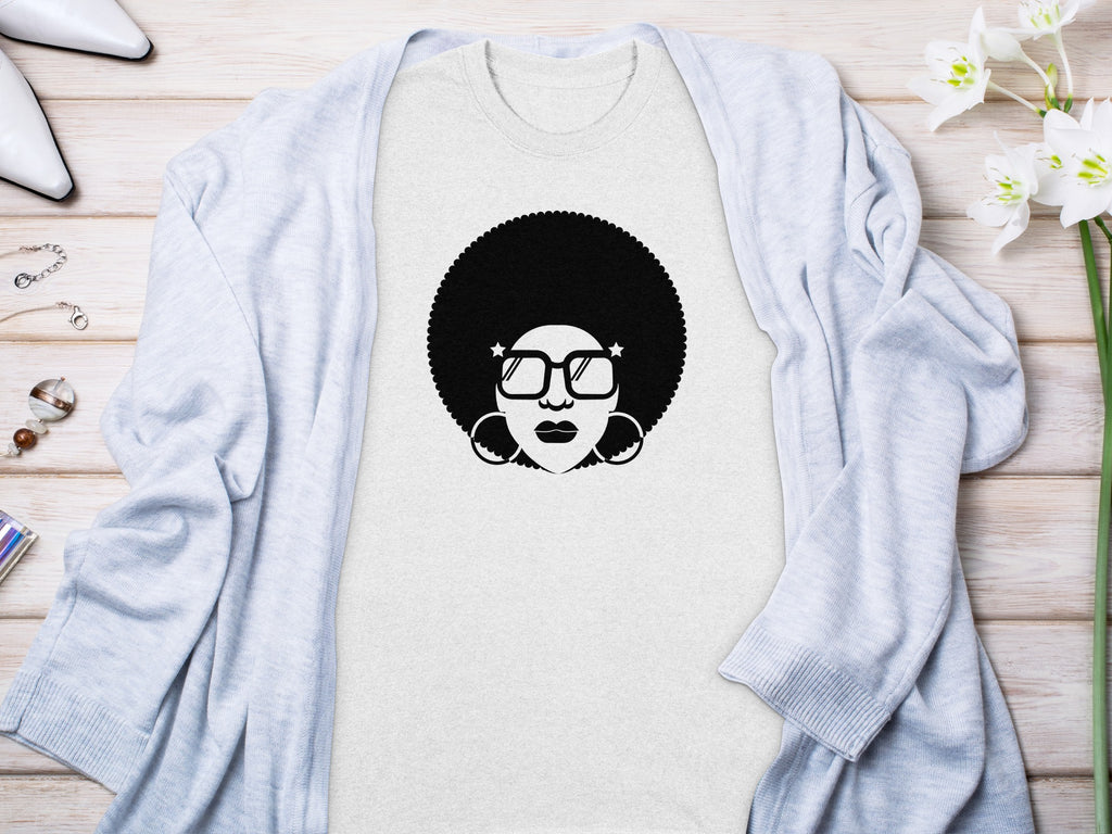 Light gray t-shirt with black graphic of afro-wearing woman in sunglasses.
