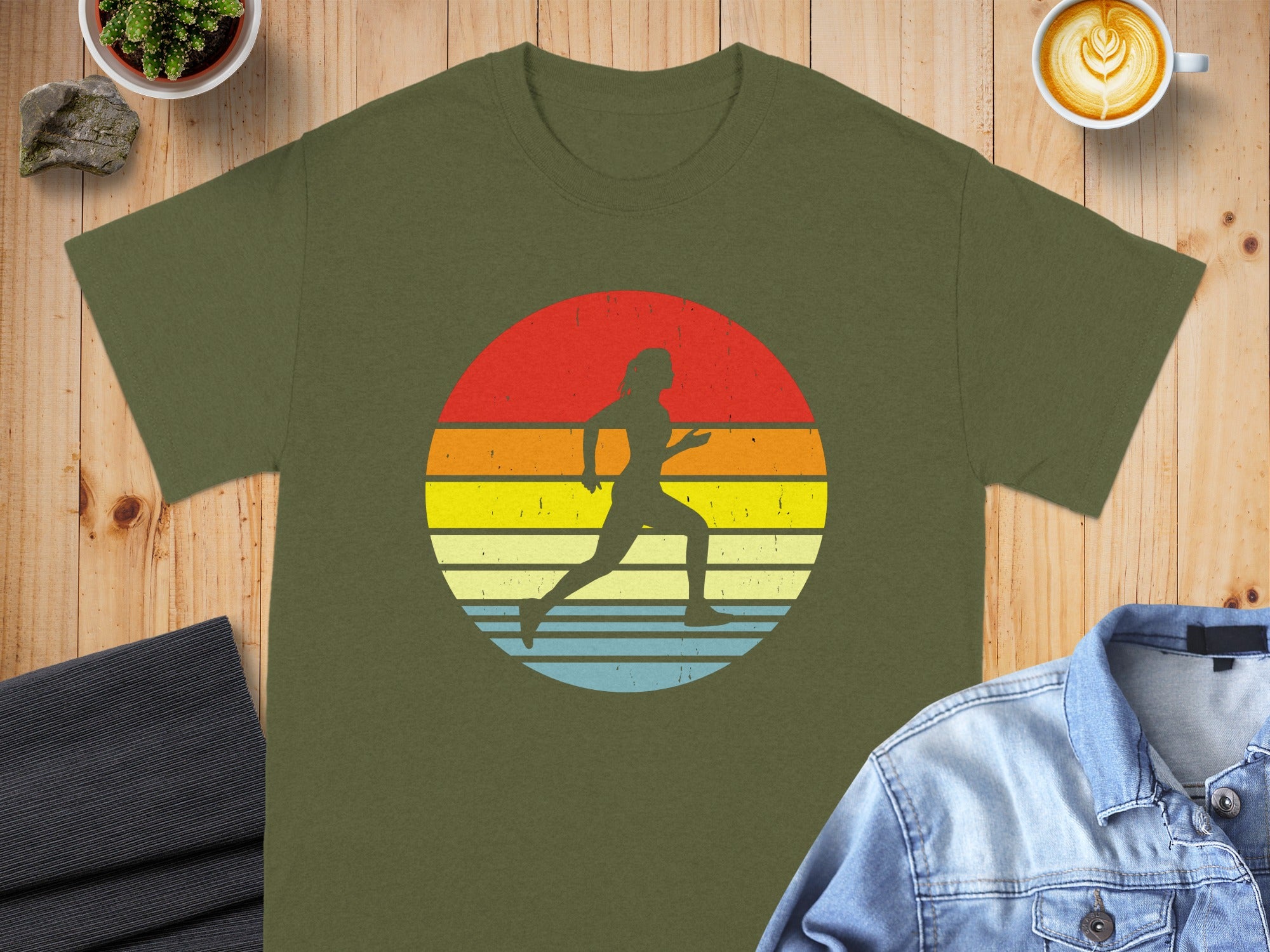 Olive green t-shirt with a silhouette of a runner within a vintage sunset circle graphic.