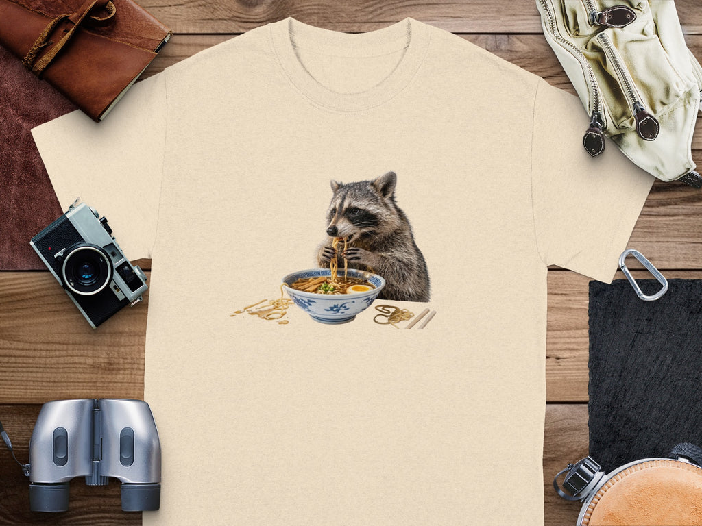 T-shirt with a graphic of a raccoon eating a bowl of ramen noodles.
