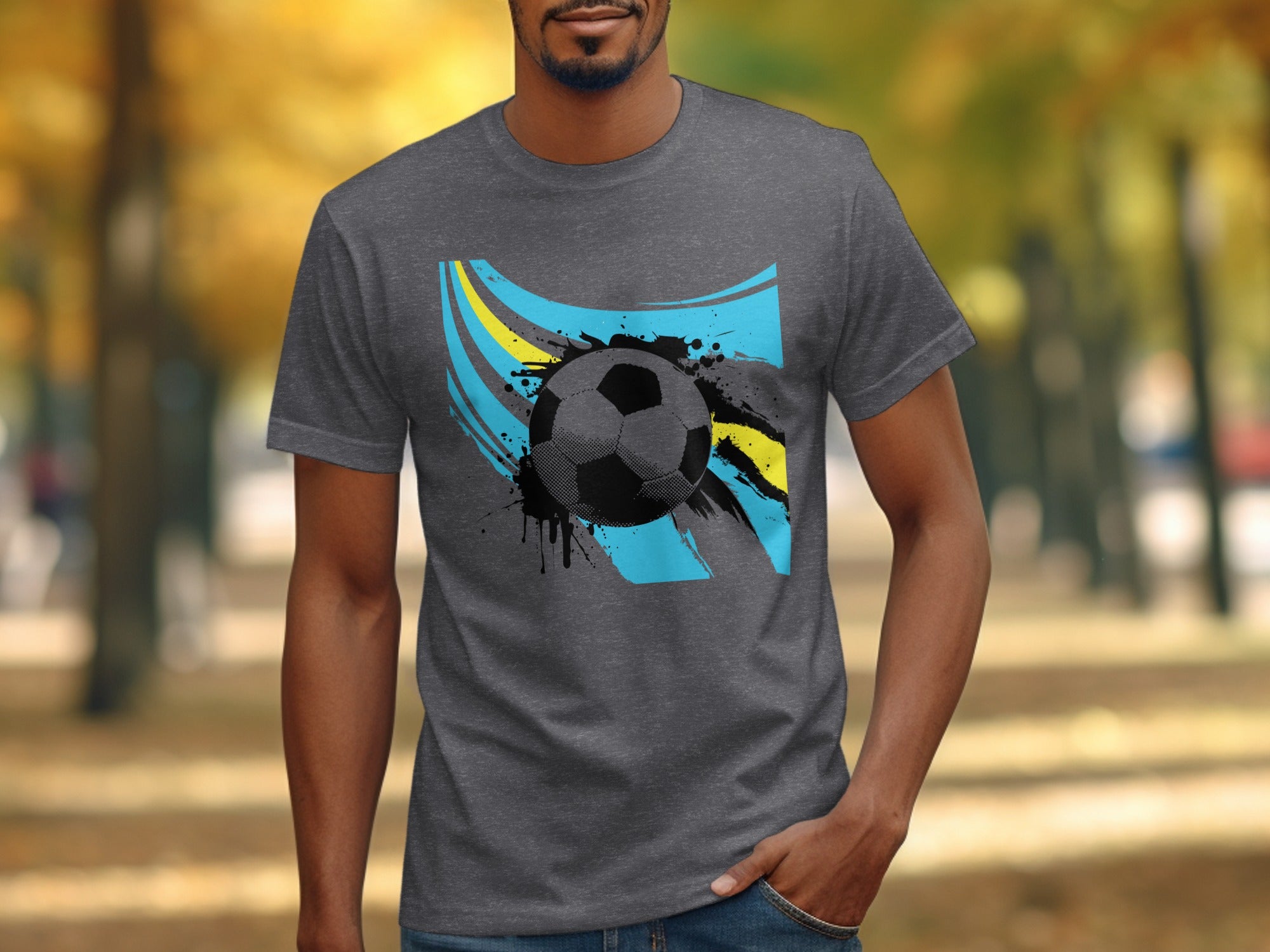Man wearing grey t-shirt with soccer ball and patriotic colors graphic.