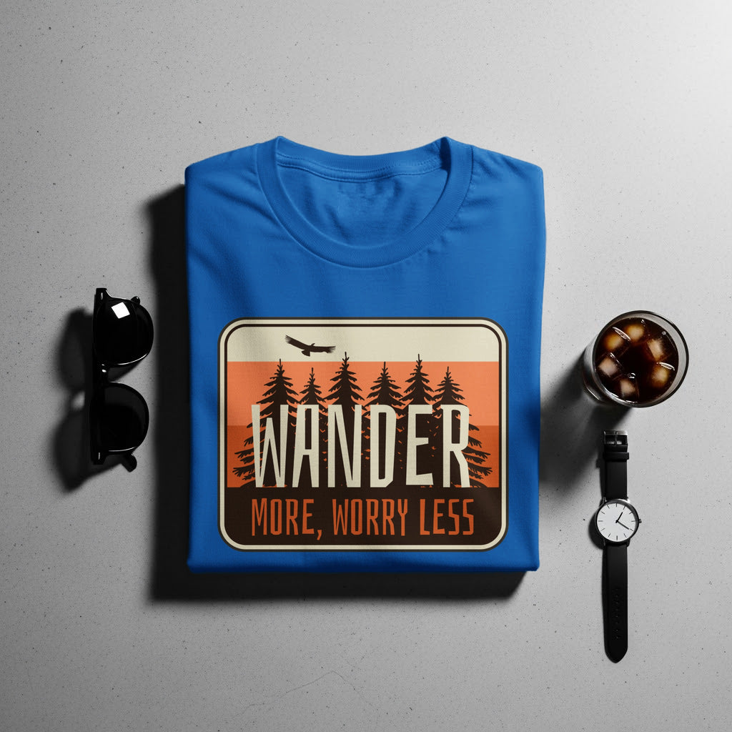 Blue t-shirt with "WANDER MORE, WORRY LESS" text and forest graphic.