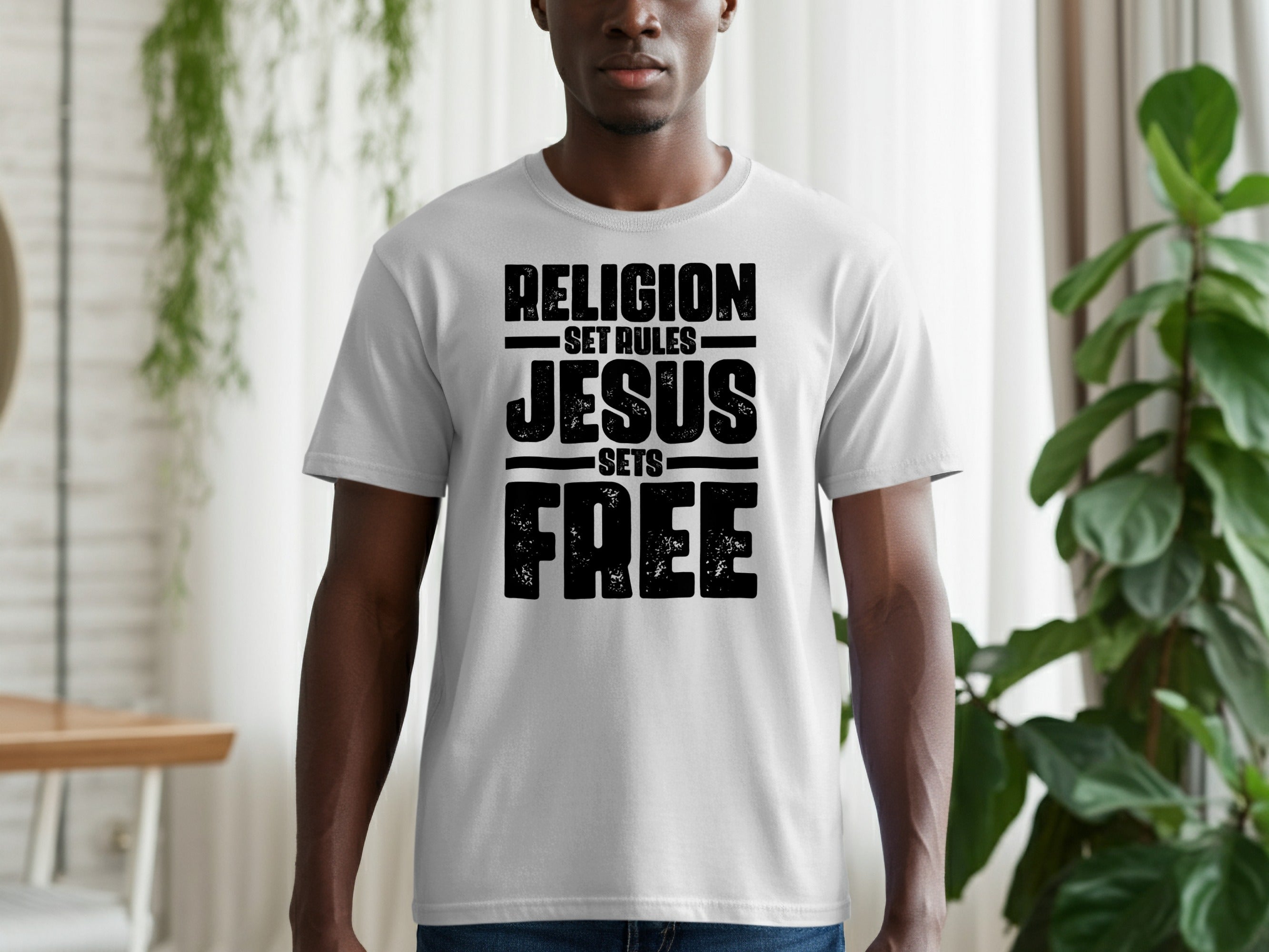 Grey t-shirt with black text: RELIGION SET RULES JESUS SETS FREE