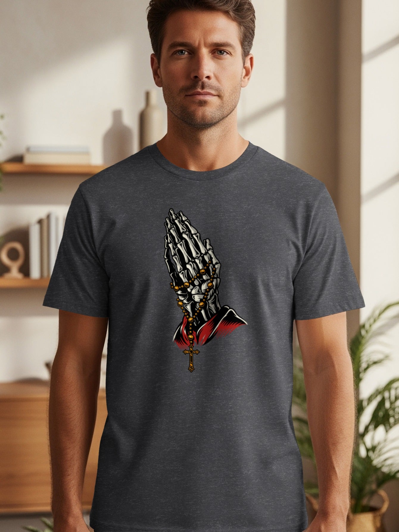 Dark grey t-shirt with graphic of skeleton hands praying with rosary beads and cross.