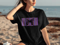 Black t-shirt with a black butterfly on a colorful striped background.