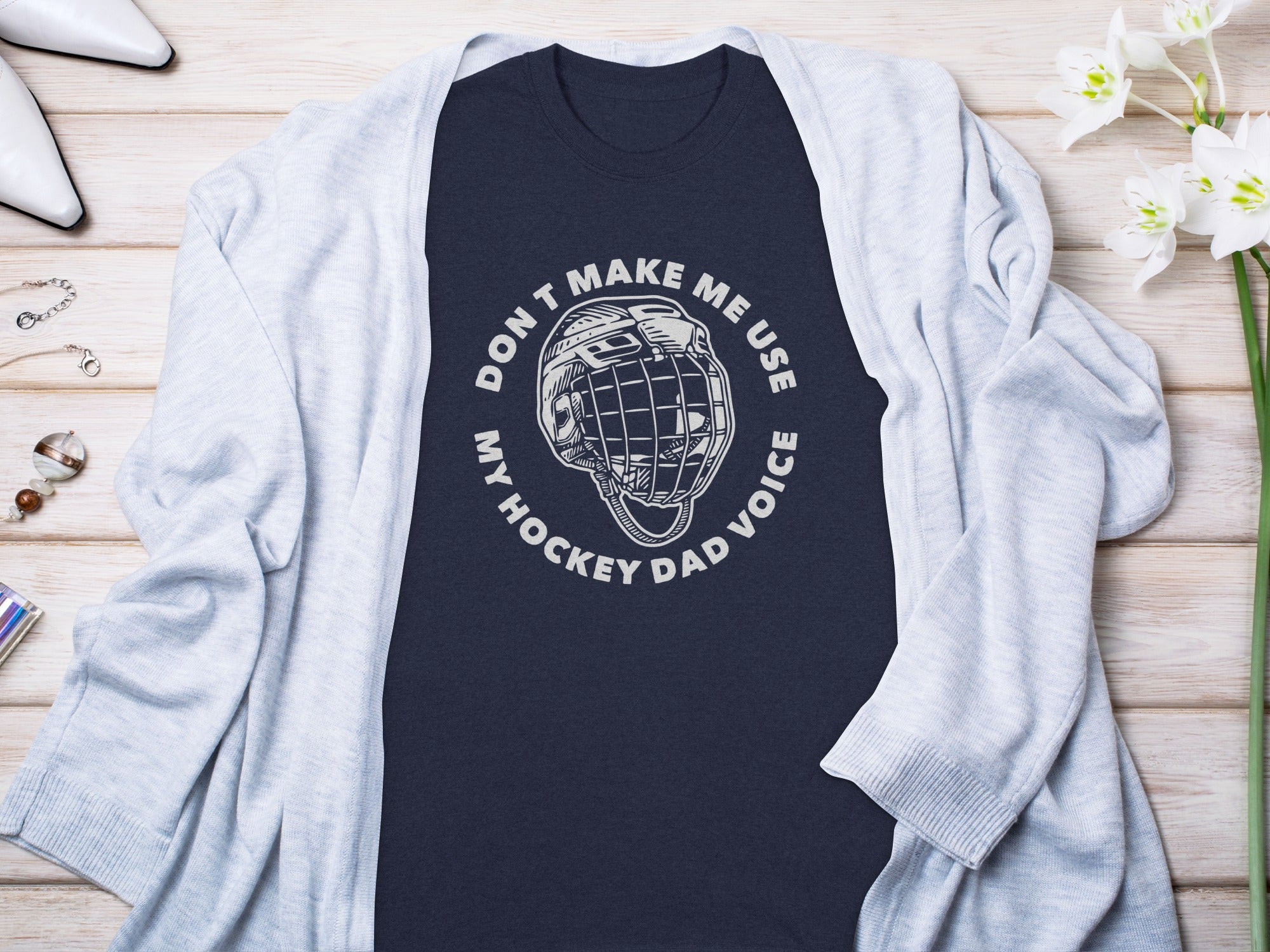 Dark blue t-shirt with white text and hockey helmet graphic.