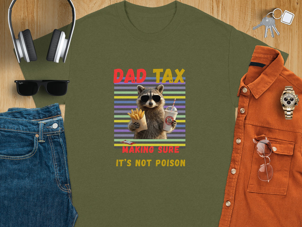 Olive green t-shirt with raccoon graphic and text "DAD TAX MAKING SURE IT'S NOT POISON".