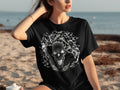 Black t-shirt with a detailed graphic skull surrounded by a smoky, abstract pattern.