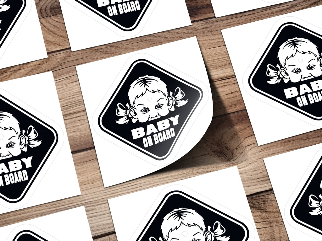"Baby on Board" sticker featuring a child's face with pigtails.
