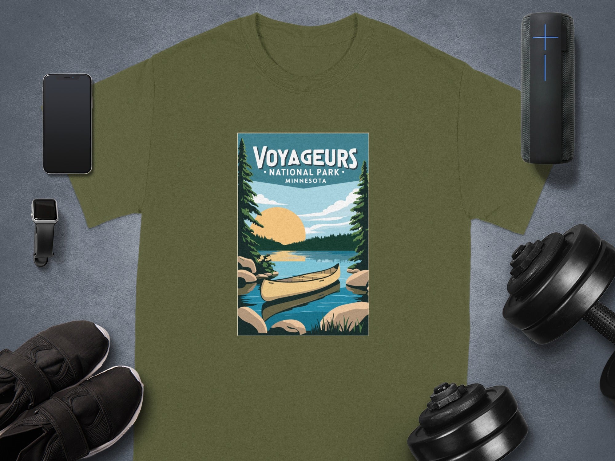 Olive green t-shirt featuring "Voyageurs National Park Minnesota" graphic with canoe.