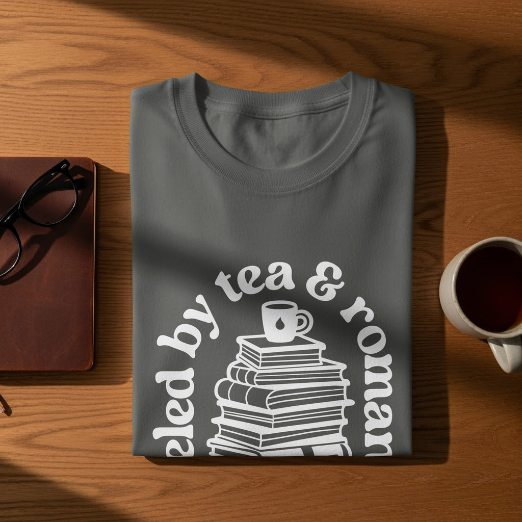 Dark grey t-shirt with white text and illustration of books.