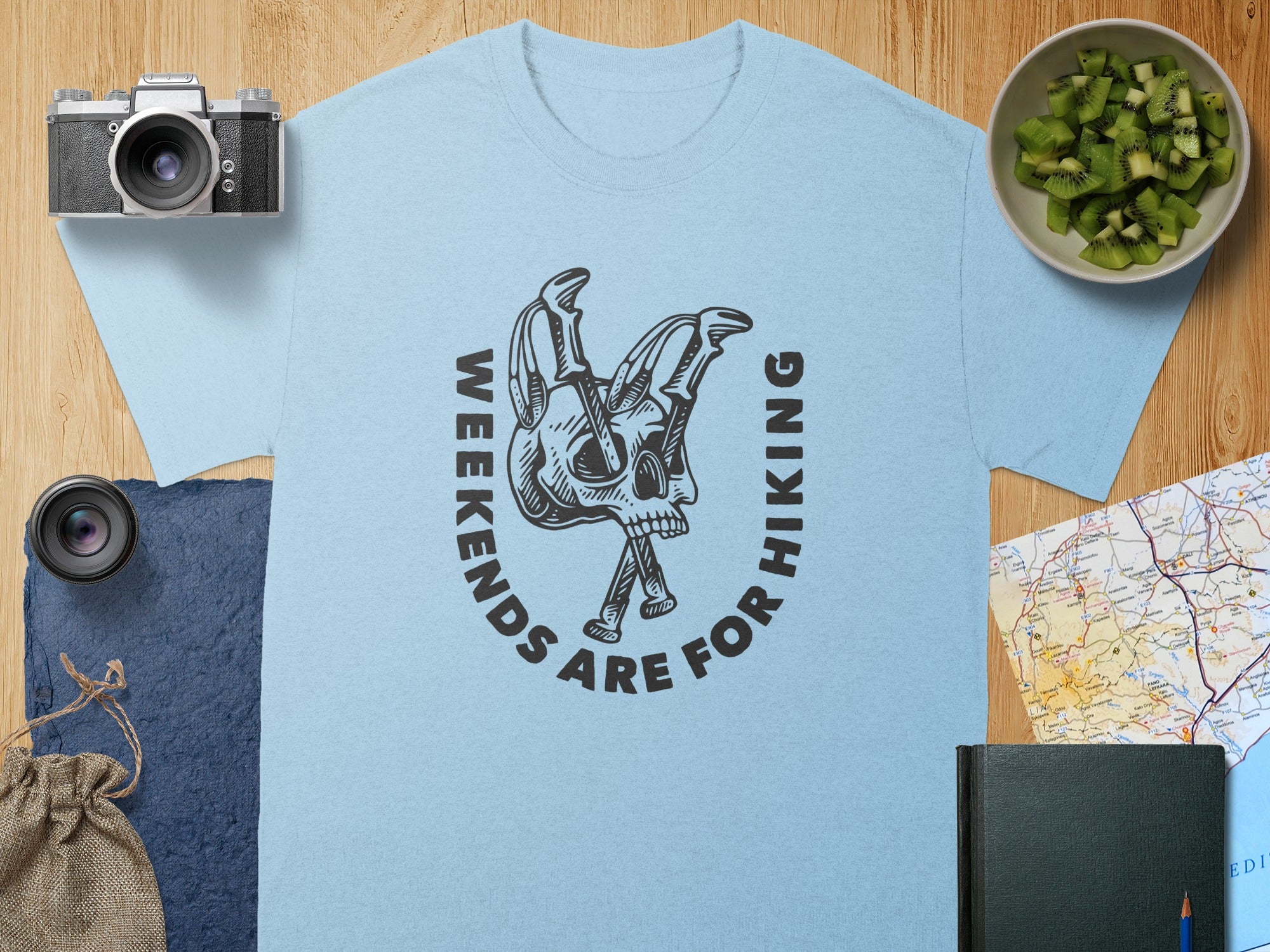 Light blue t-shirt with "Weekends Are For Hiking" text and skull design.