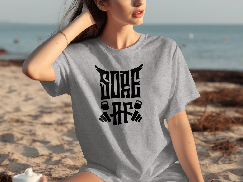 Grey t-shirt with "SORE AF" text and barbell and kettlebell graphics.