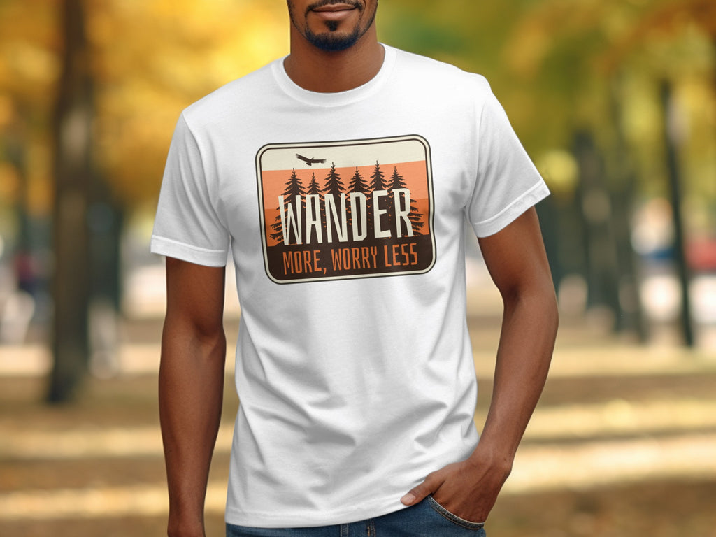 White t-shirt with a graphic that says "WANDER MORE, WORRY LESS".