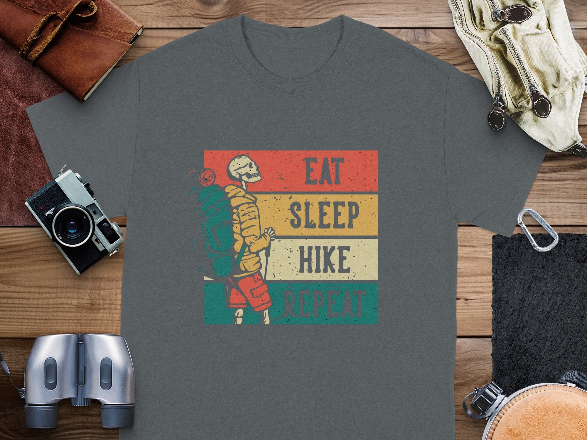 Skeleton hiker graphic with text "Eat Sleep Hike Repeat" on a t-shirt.