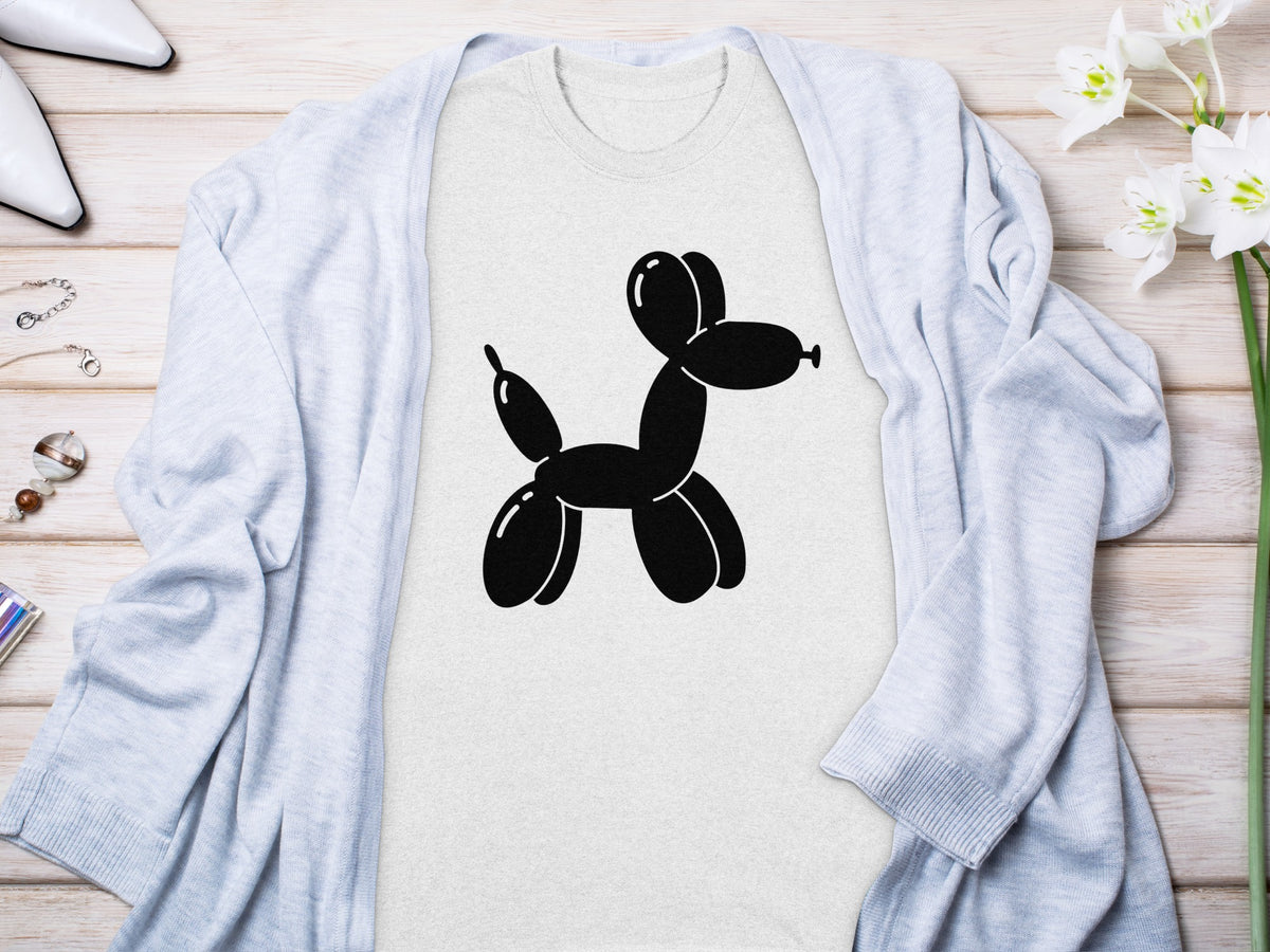 Gray t-shirt with a black balloon dog graphic, layered under a light blue cardigan.