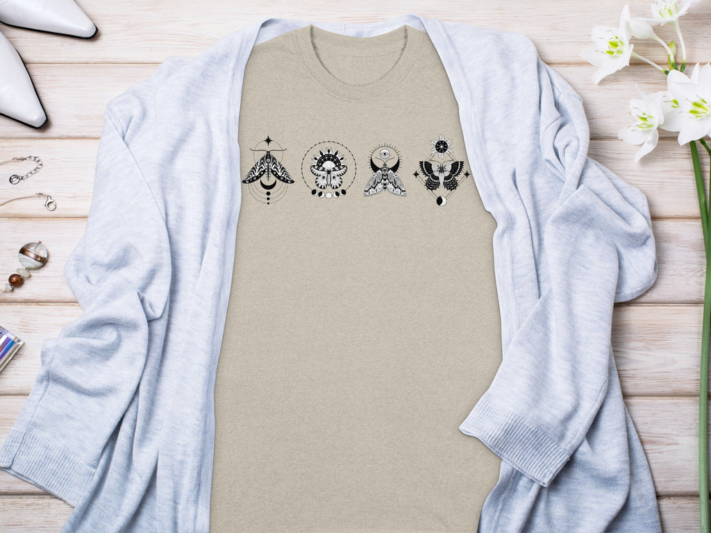 Light beige t-shirt with four black celestial moth designs.
