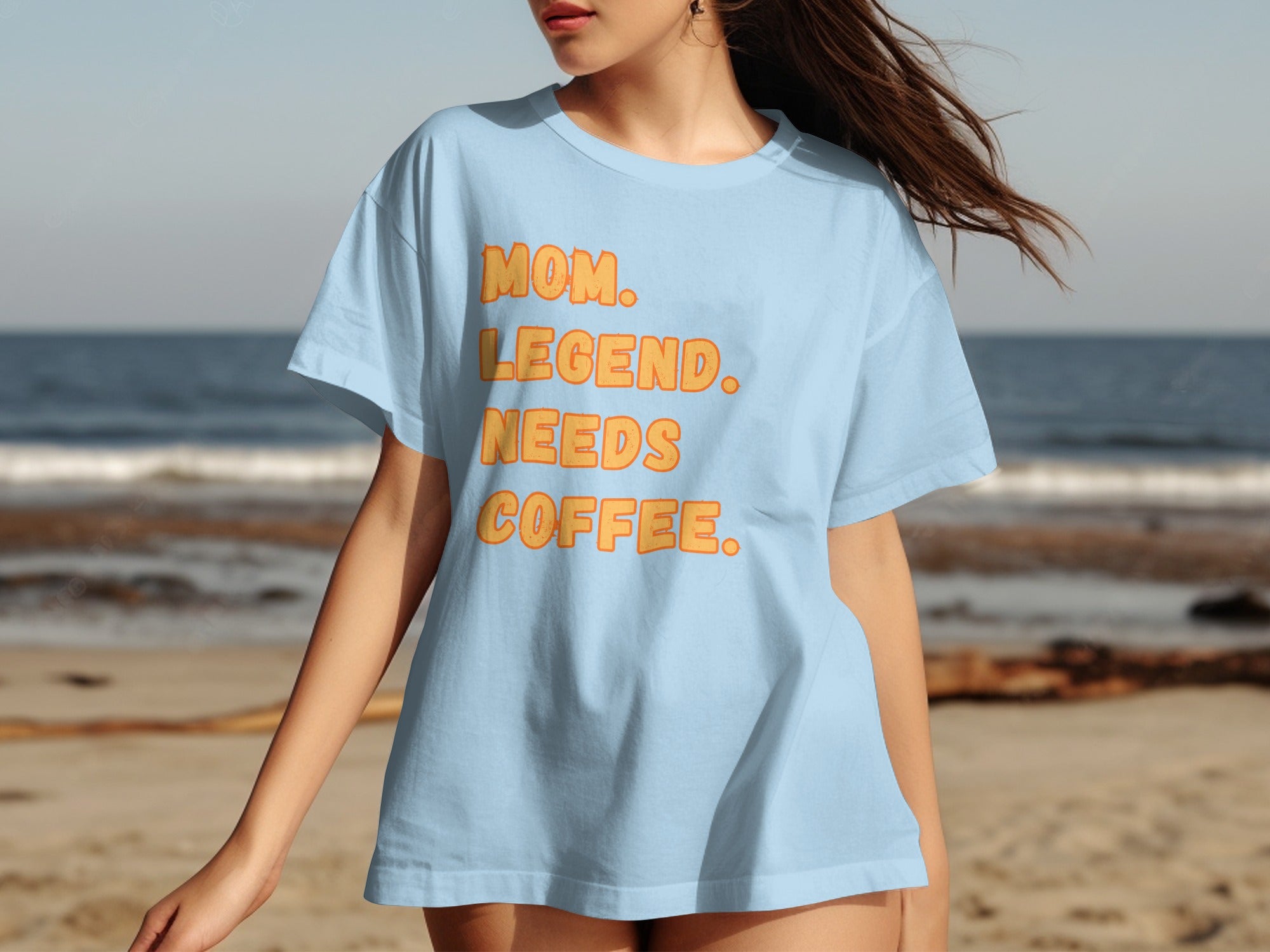 Light blue t-shirt with orange text reading "MOM. LEGEND. NEEDS COFFEE."