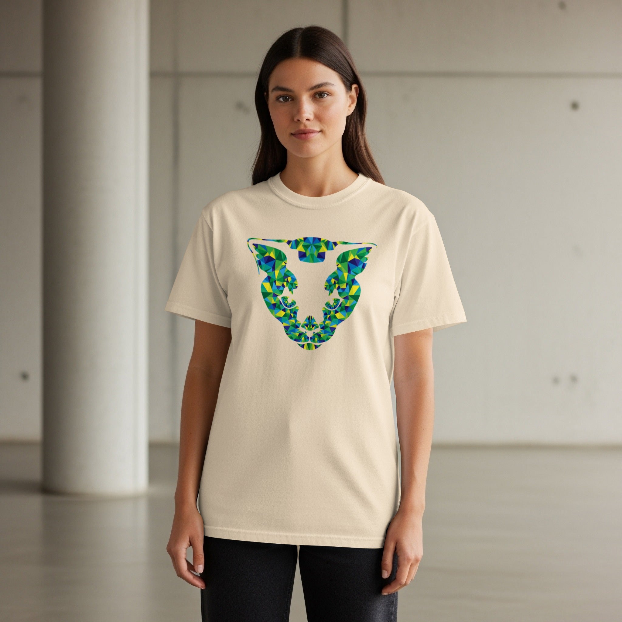 Cream t-shirt with geometric green and blue bull head graphic on chest.