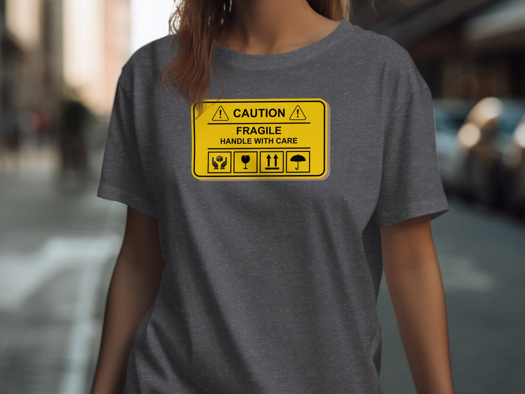 Dark grey t-shirt featuring a caution fragile handle with care sign graphic.
