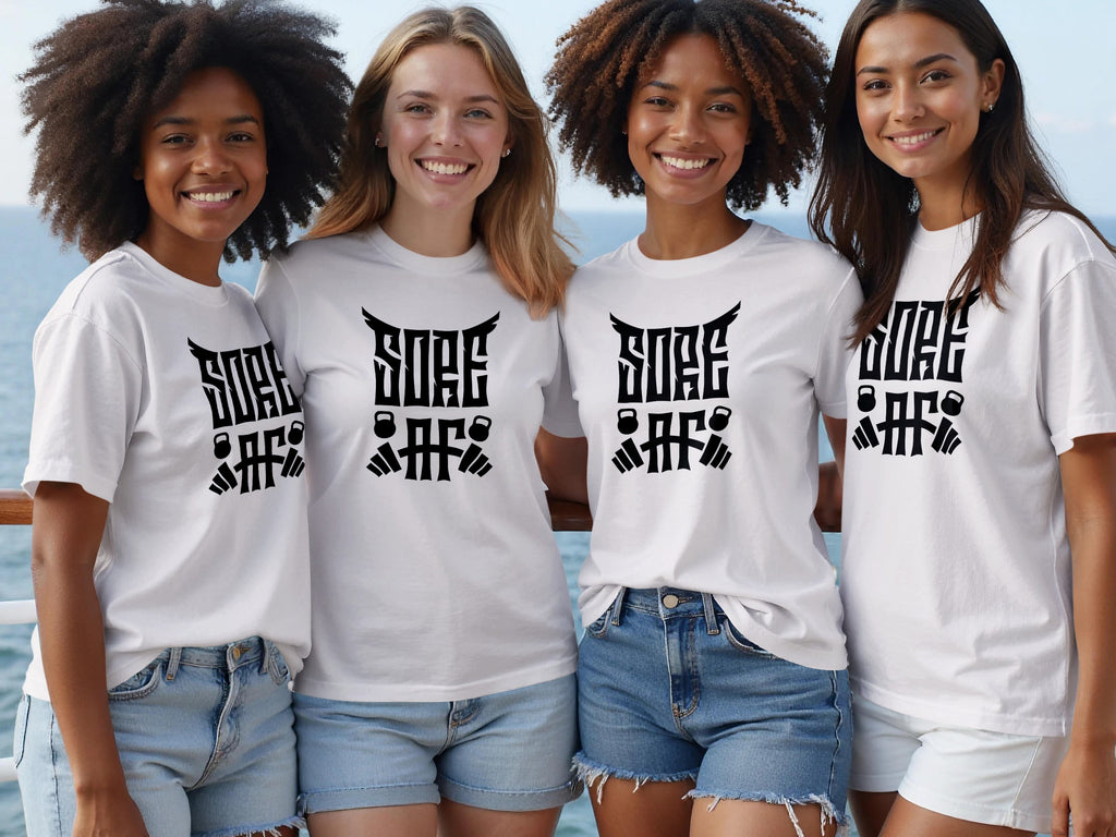 Four women in white t-shirts with "SORE AF" and barbell graphics stand on a deck.