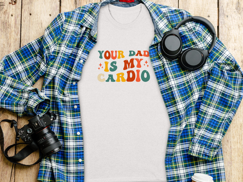 Heather tee with colorful retro text reading "Your Dad Is My Cardio".