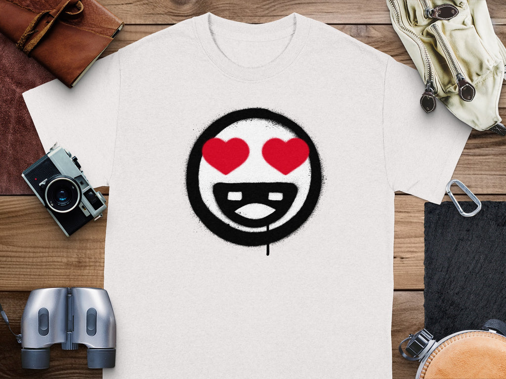 White t-shirt with black spray-painted graffiti smiley face with red heart eyes.
