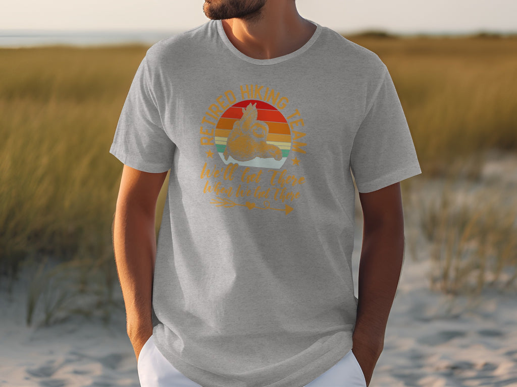 Grey t-shirt with "Retired Hiking Team" text and sunset graphic.
