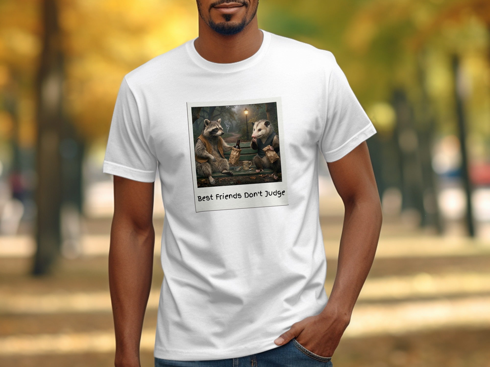 White t-shirt with a polaroid of a raccoon and possum sitting on a bench drinking.