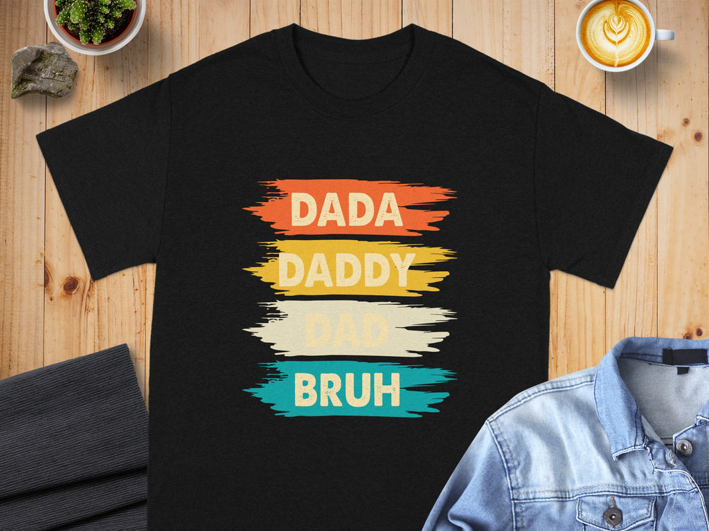 Black t-shirt with "DADA DADDY DAD BRUH" text in retro colors.