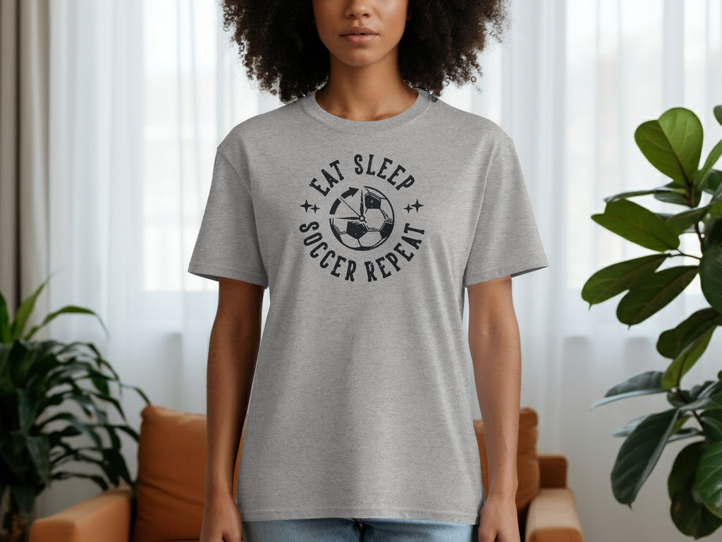 Grey t-shirt with "Eat Sleep Soccer Repeat" text and soccer ball graphic.