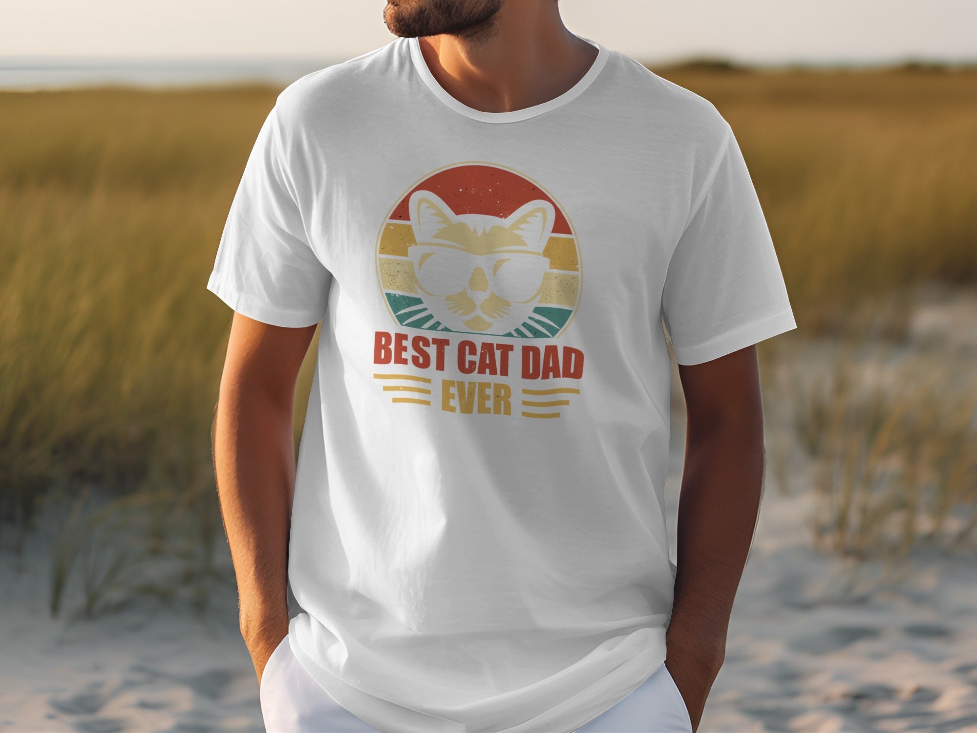 White t-shirt with graphic of a cat in sunglasses and text "BEST CAT DAD EVER".
