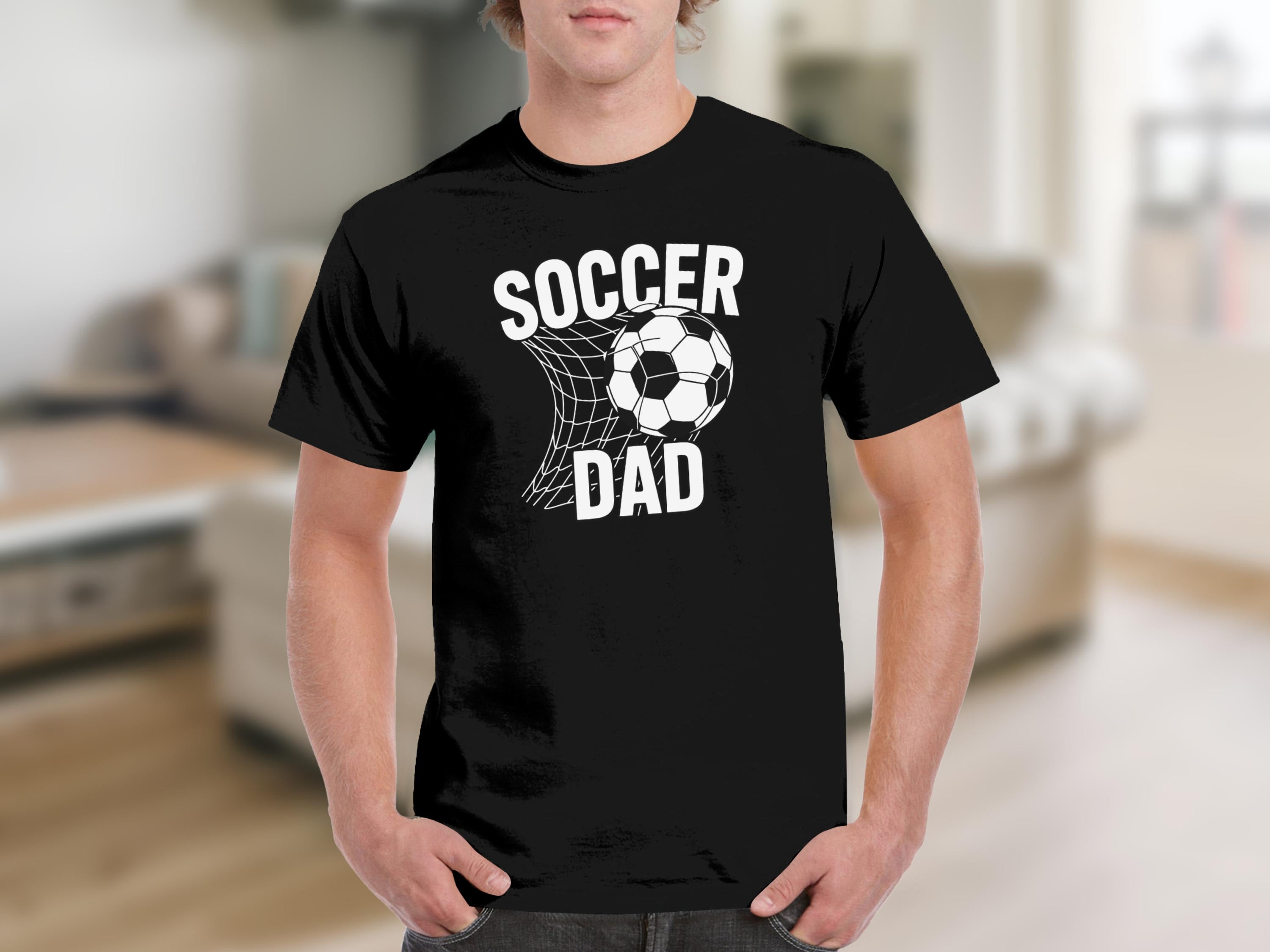 Black t-shirt with white text "SOCCER DAD" and soccer ball in net graphic