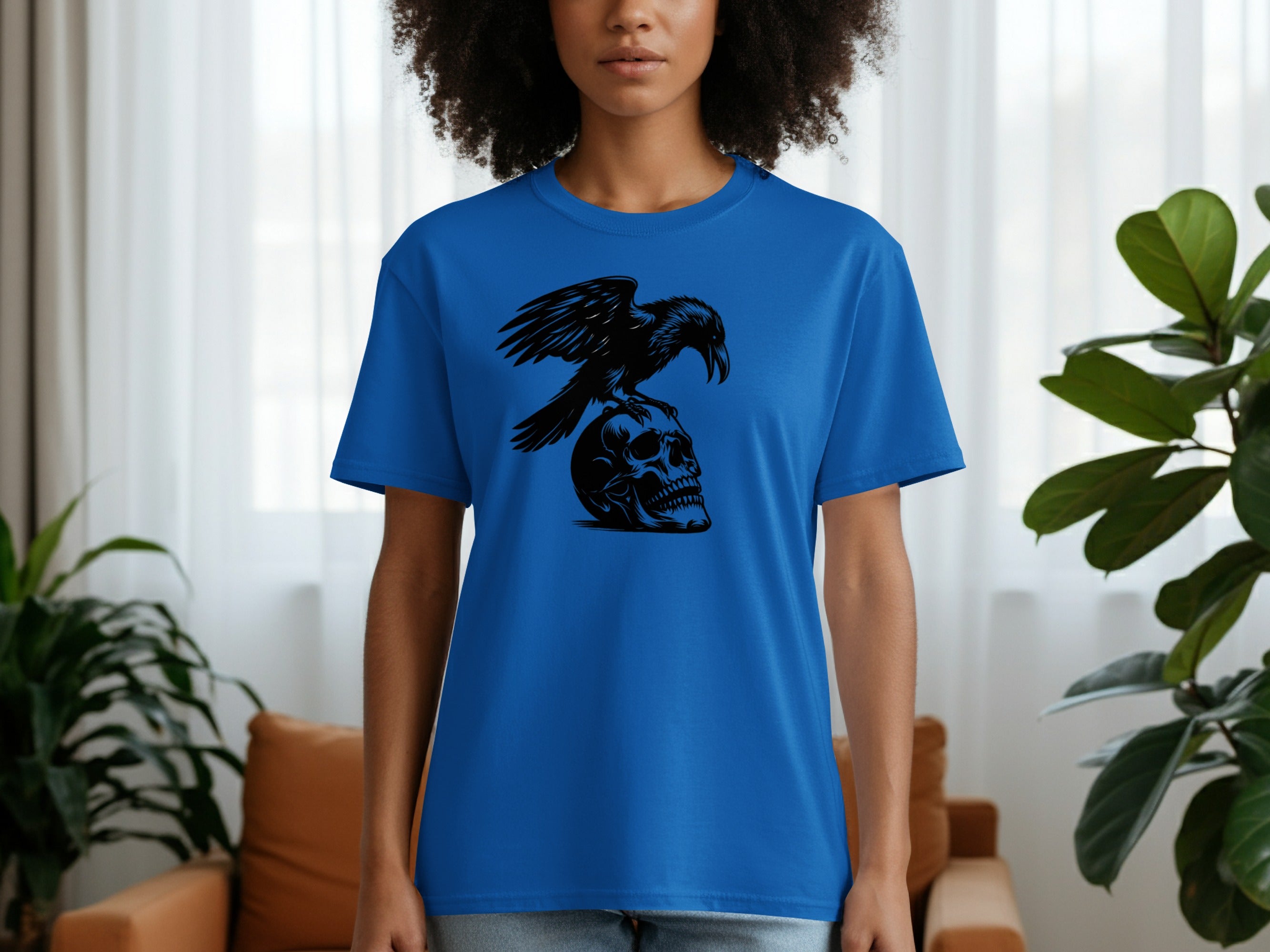 Blue t-shirt with a black crow perched on a skull graphic.