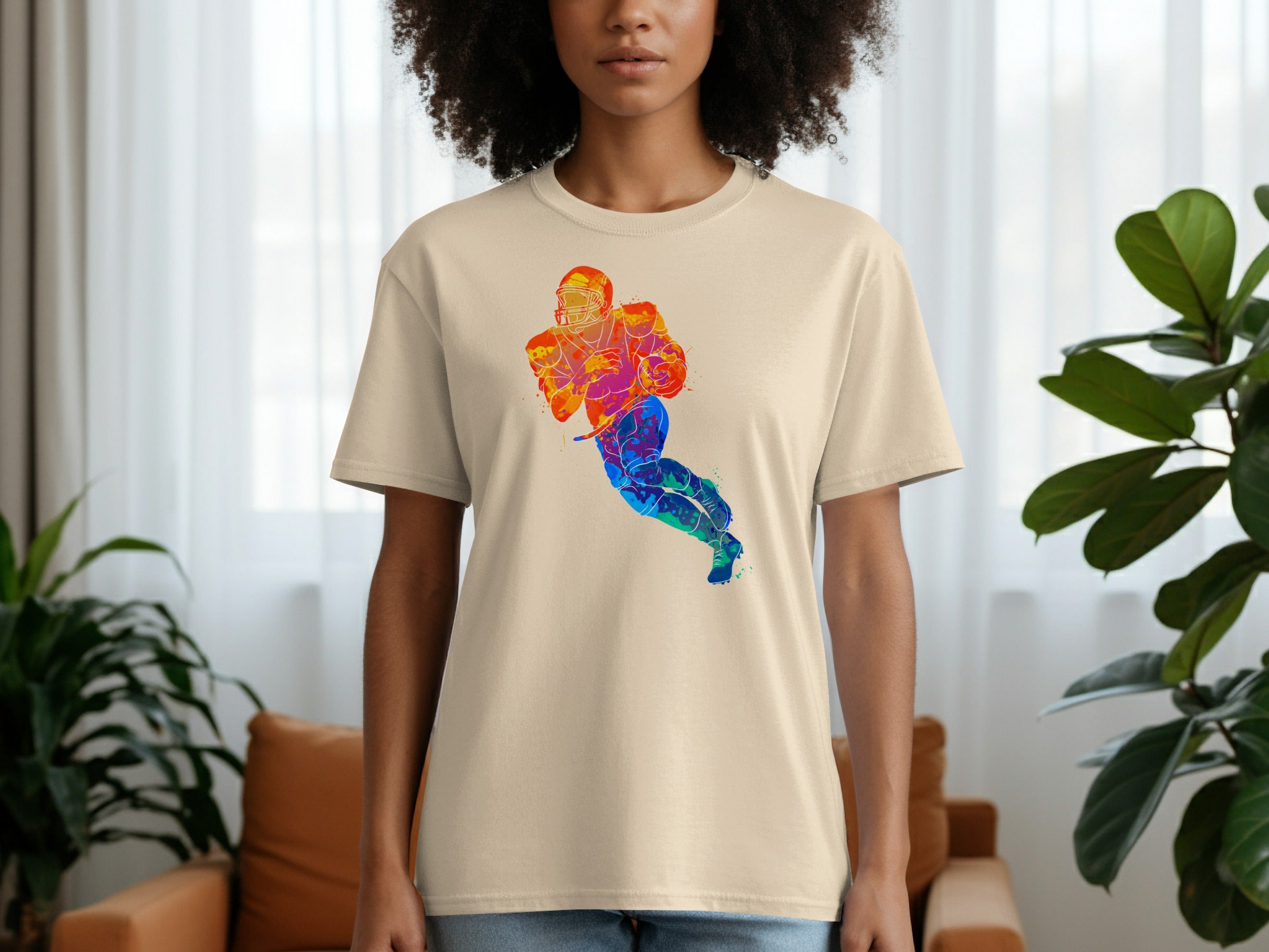 Cream t-shirt with a colorful watercolor football player design.