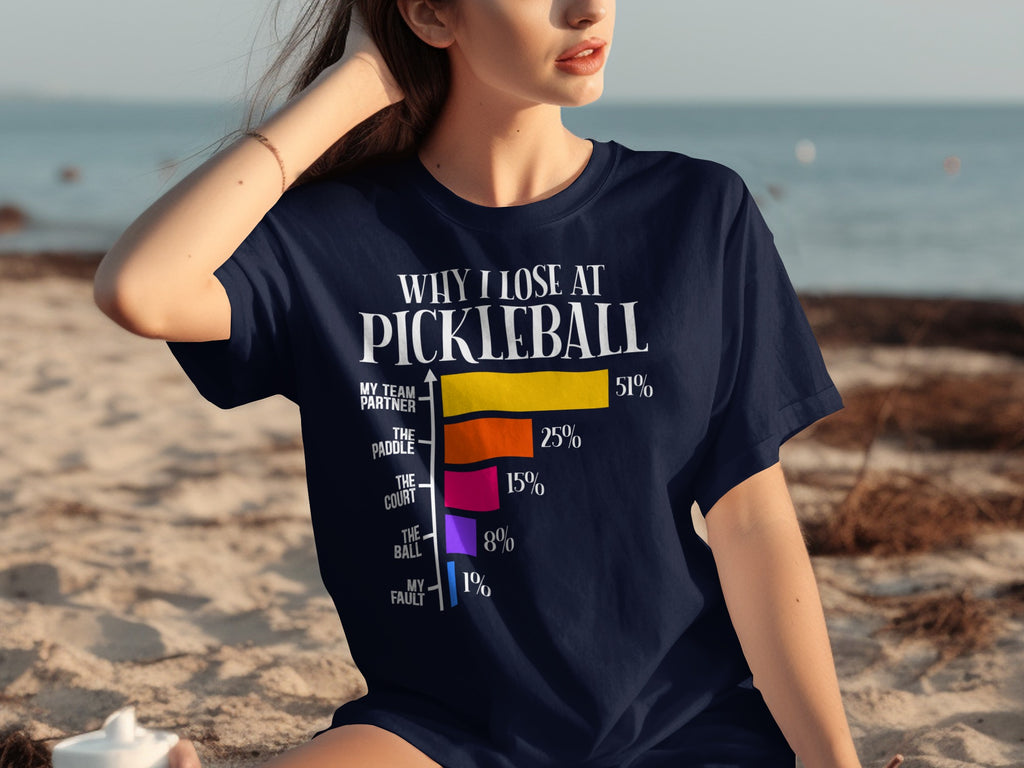 Navy t-shirt with "Why I Lose at Pickleball" and a bar chart of excuses.