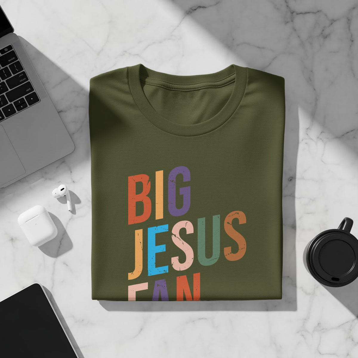Green t-shirt with colorful "BIG JESUS FAN" text and distressed texture.