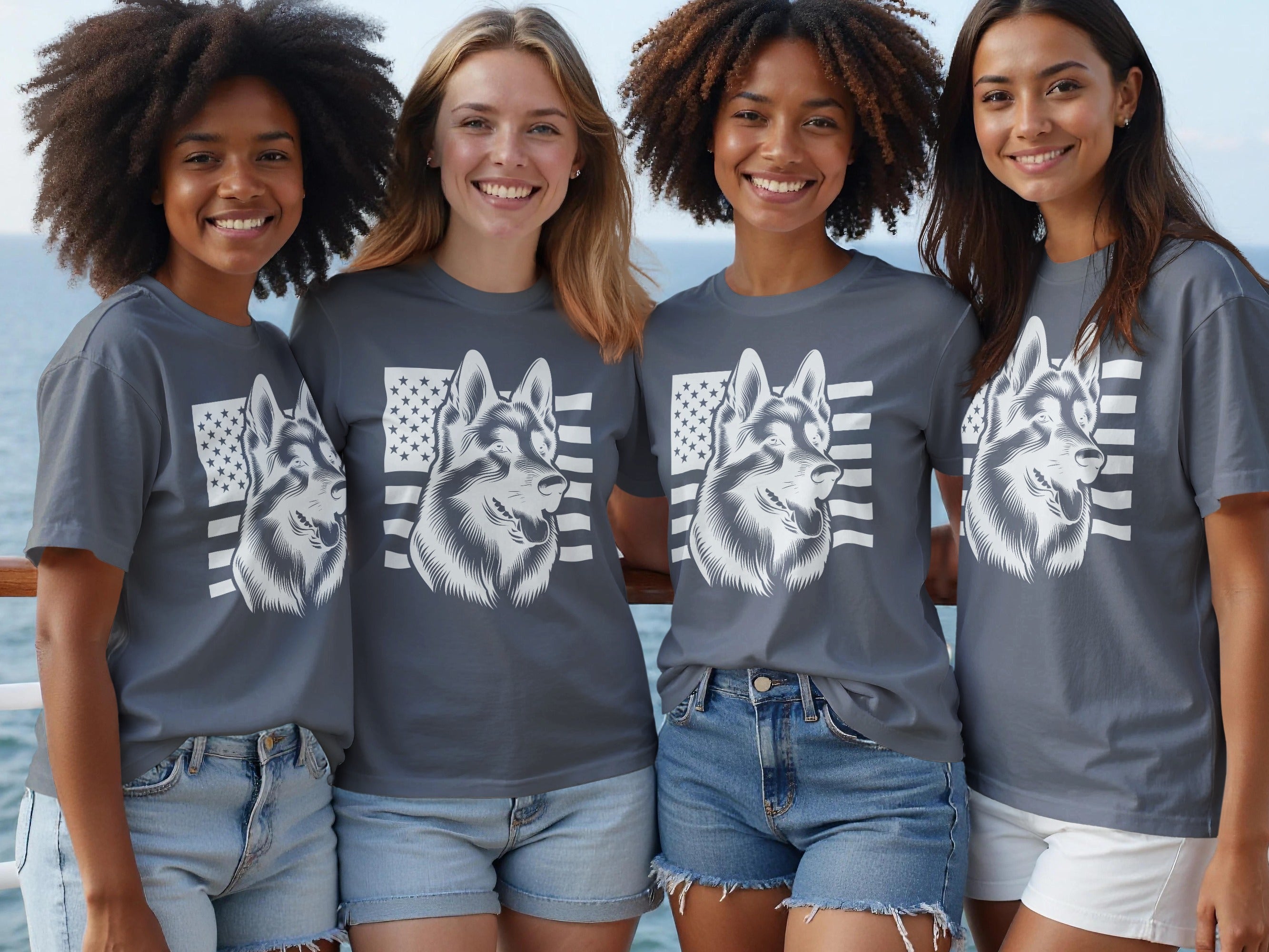 Four diverse women smile while wearing t-shirts with a dog and American flag design.