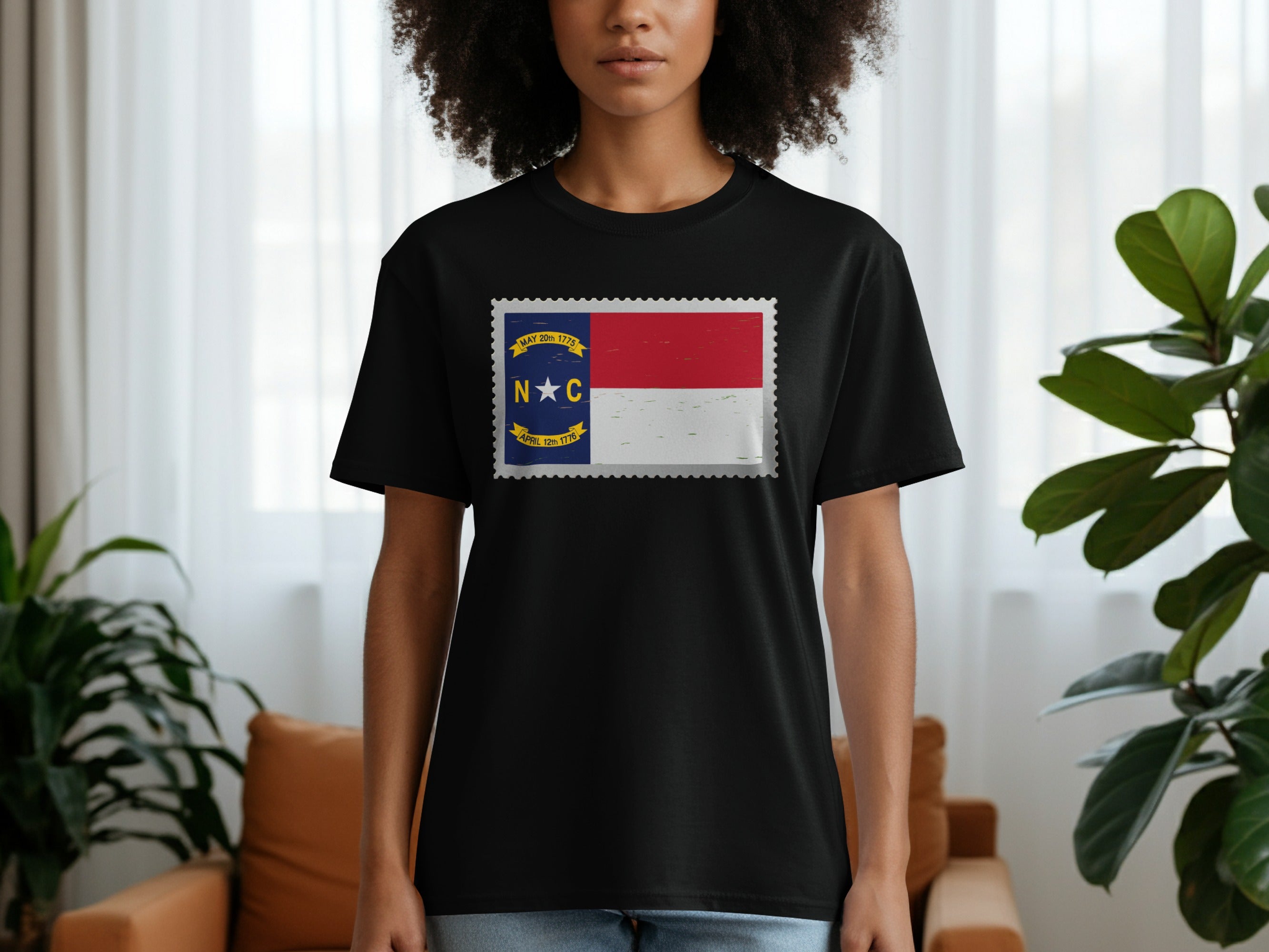 Black t-shirt featuring a North Carolina flag design in a stamp graphic.