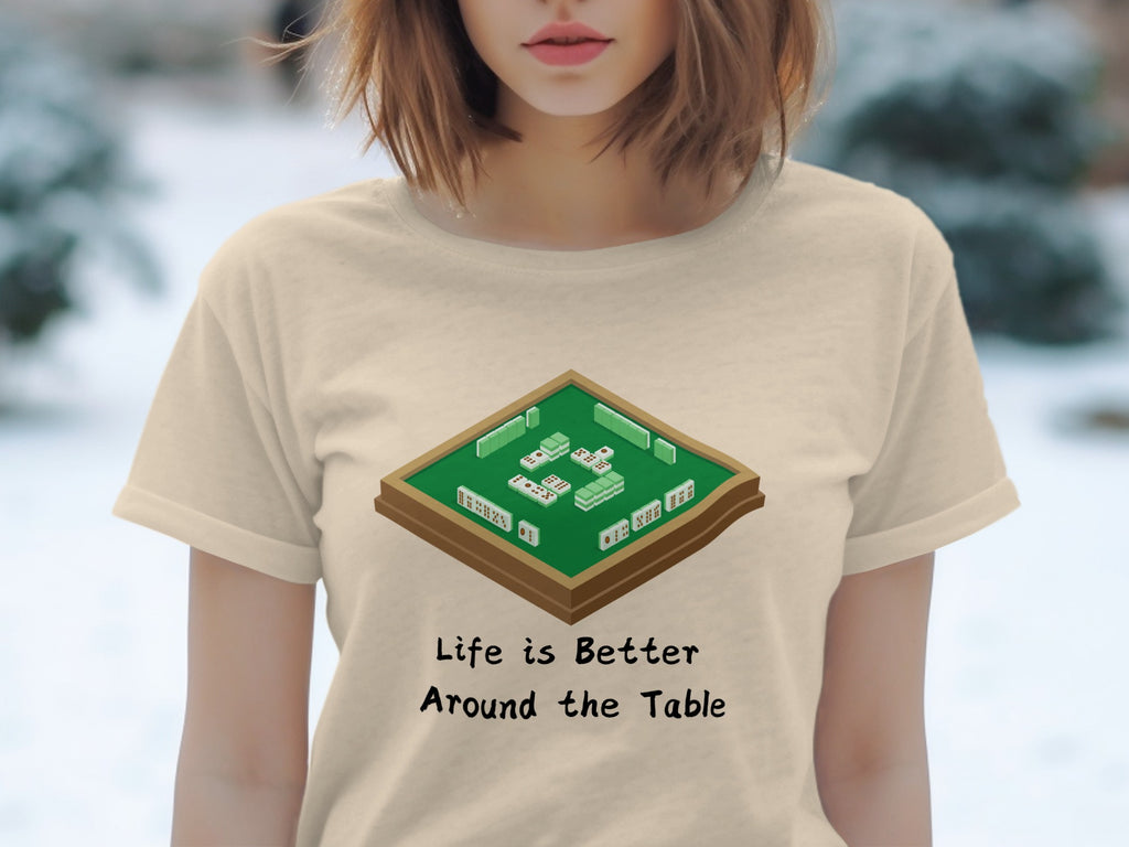 Mahjong table graphic with text "Life is Better Around the Table" on shirt.