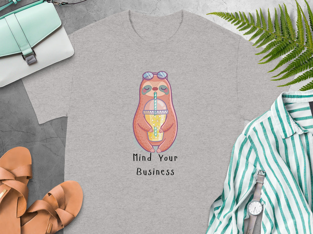 Grey t-shirt with cartoon sloth illustration and text "Mind Your Business".