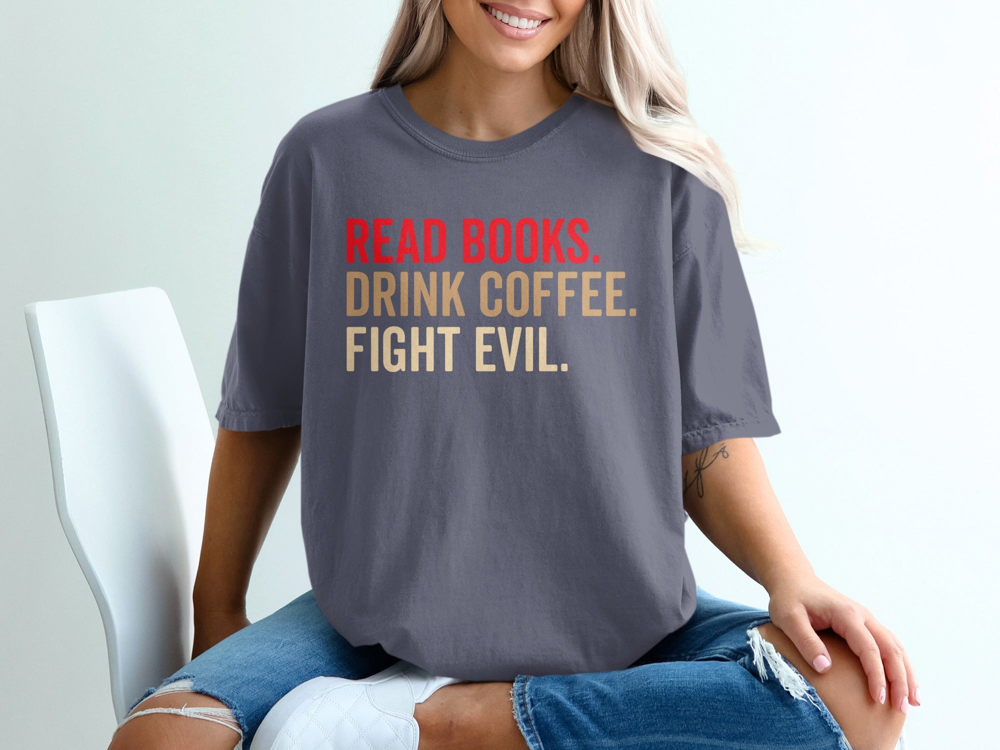 Dark grey t-shirt with red and gold text reading "Read Books. Drink Coffee. Fight Evil."